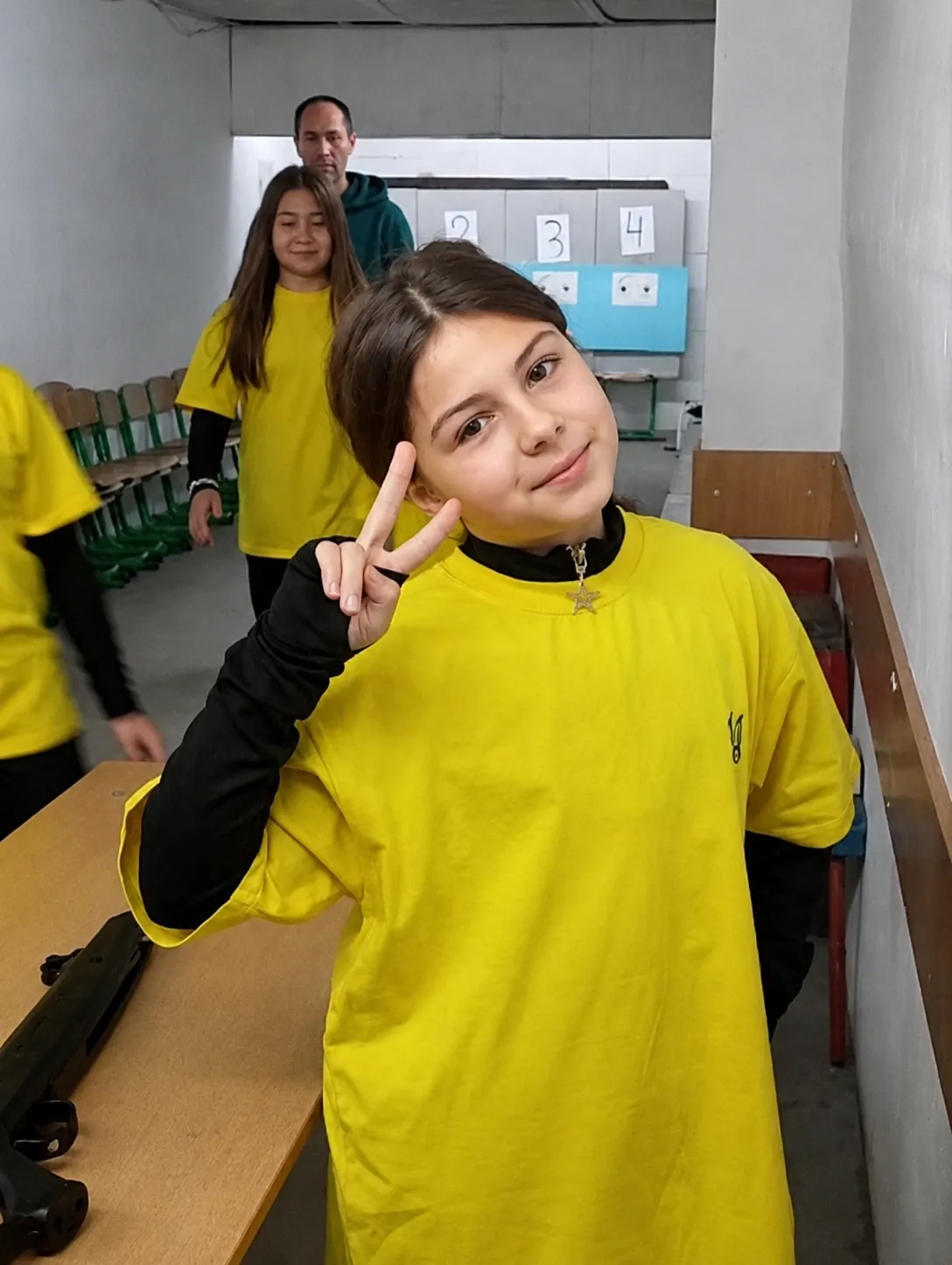 Ukrainian girl wearing yellow shirt with peace sign