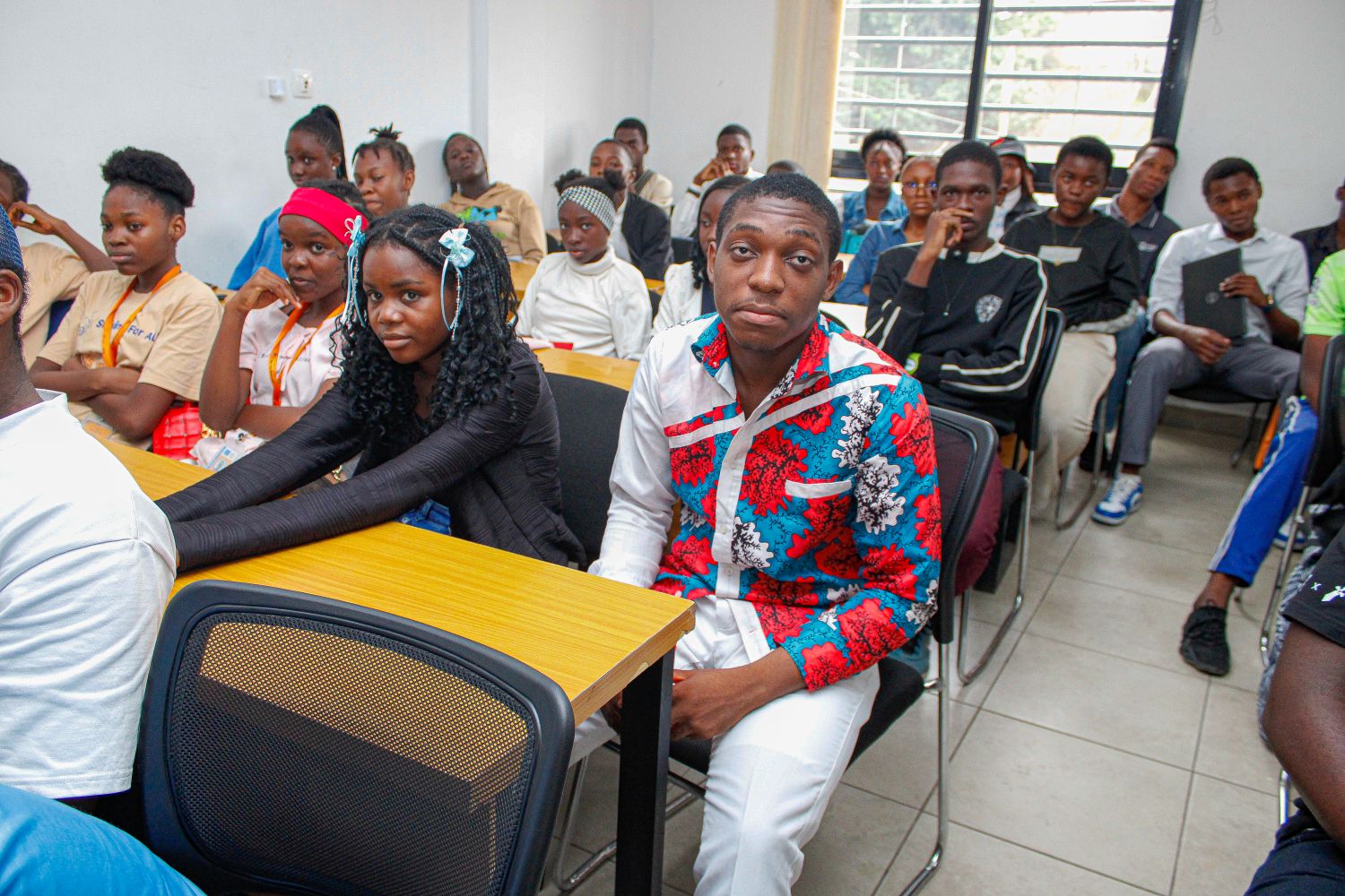 Students attentif to Striving for all founder Genevieve Ngambia