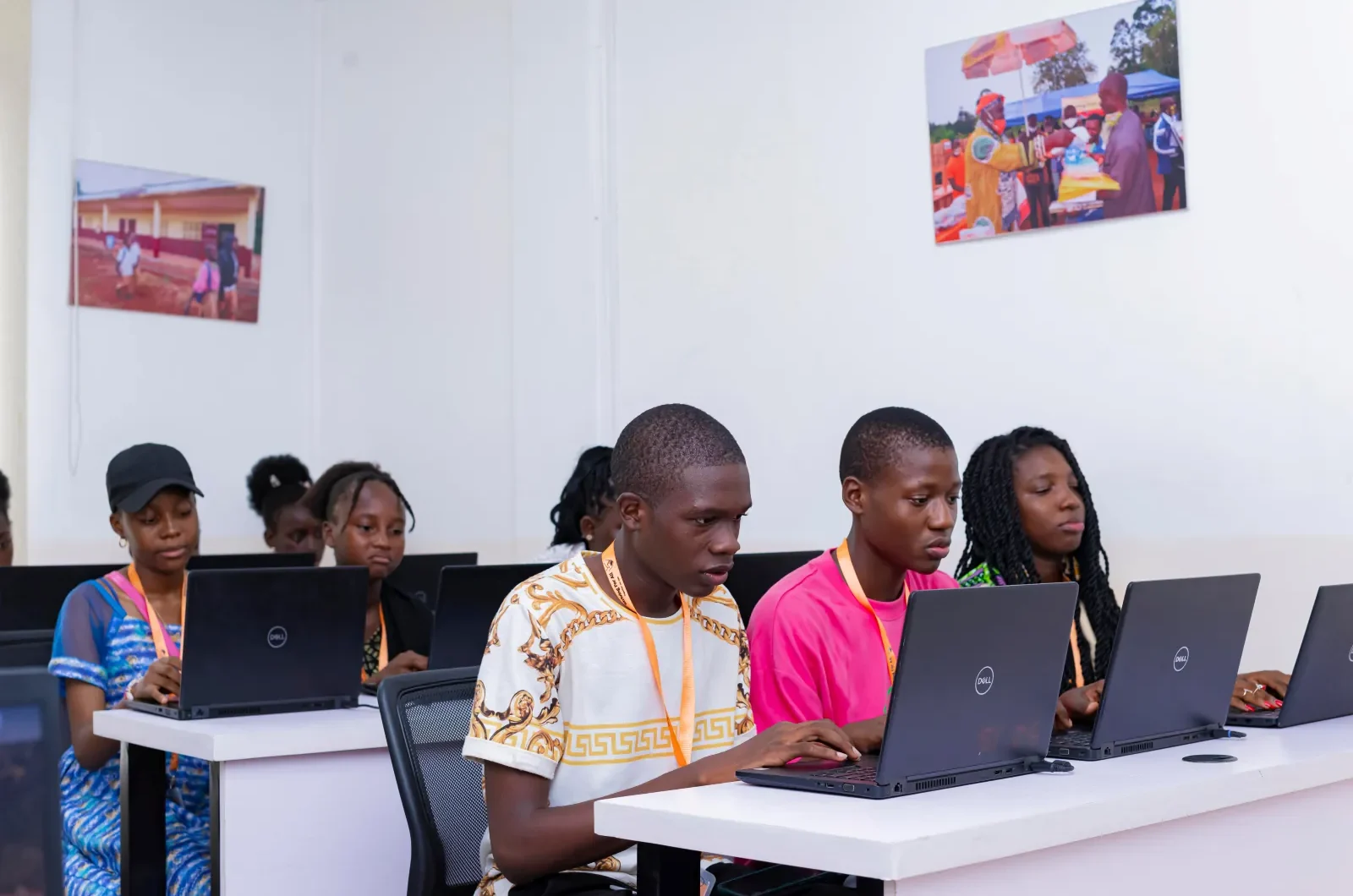 students in classroom with laptops on their desk